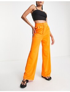Pantalones naranjas de pernera muy ancha con botones de Extro & Vert