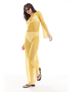 Vestido largo amarillo con espalda escotada y detalle de lazada de croché transparente de Something New styled by Claudia Bhimra
