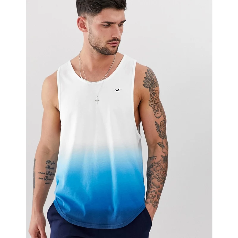 Camiseta sin mangas con bajo redondeado y logo icónico con diseño desteñido blanco a azul de Hollister - GLAMI.es